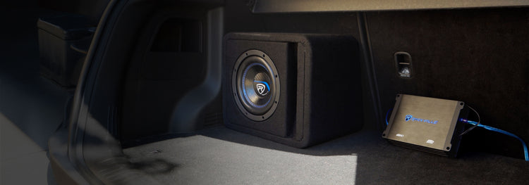 Car subwoofer and amplifier in a vehicle's trunk.