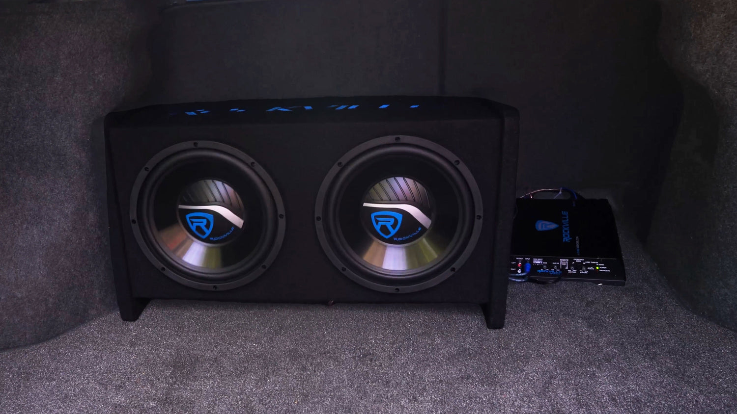 Car subwoofer system with visible brand logo on a dark background